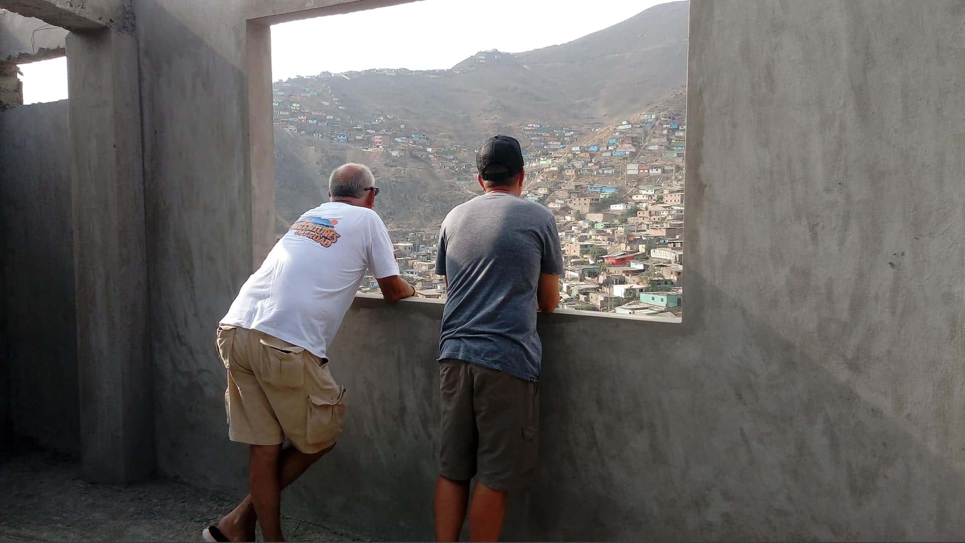 Men looking out over the outskirts of Lima | Responsible Travel Peru