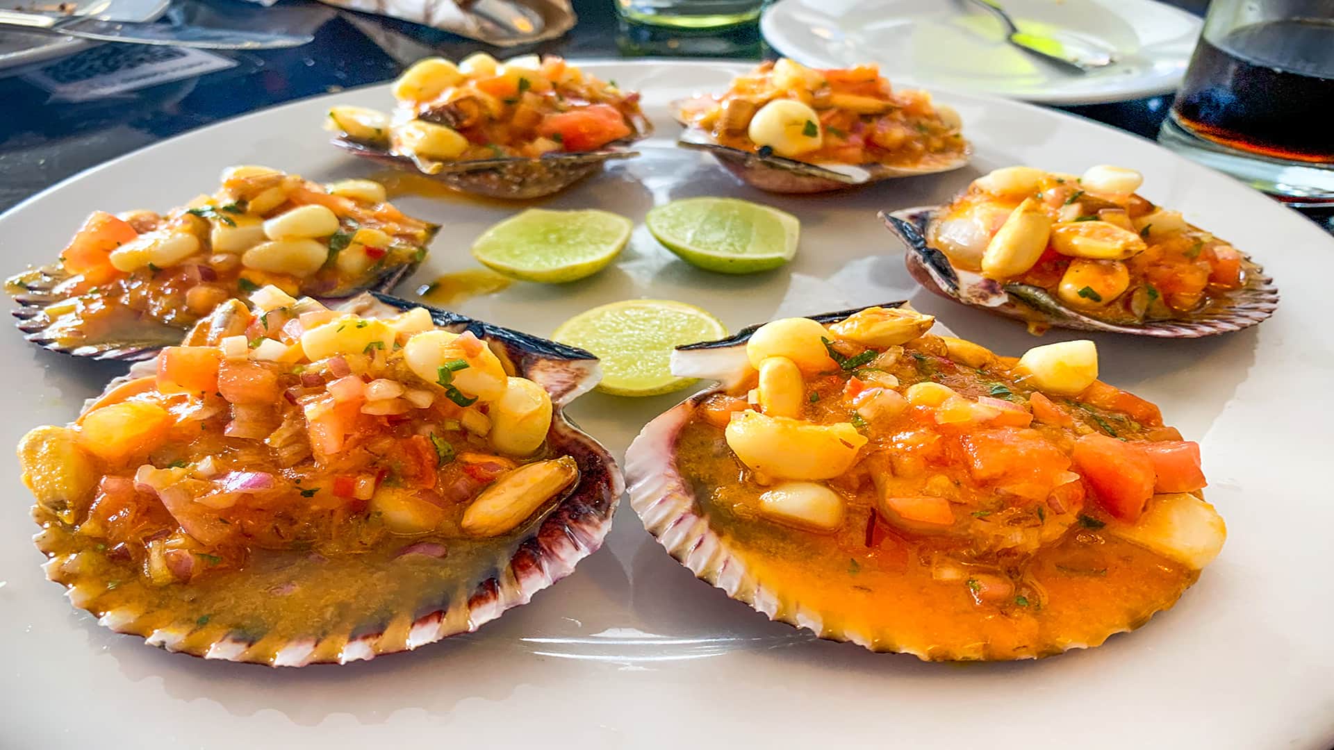 Large shells filled with fresh ceviche at Cabos Restaurant in Callao, seen during a tour with Responsible Travel Peru