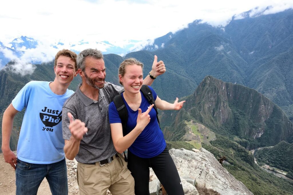 Father with teenage kids in Machu Picchu. Family-friendly tours from Responsible Travel Peru