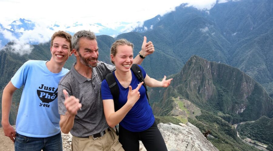 Father with teenage kids in Machu Picchu. Family-friendly tours from Responsible Travel Peru