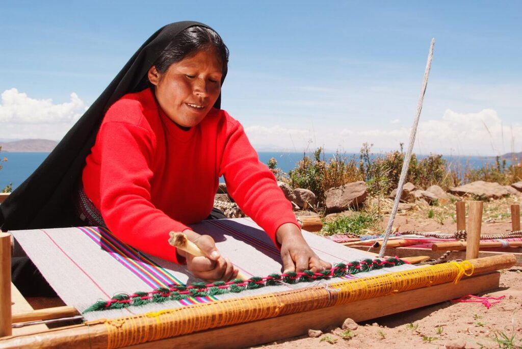 Weaving lady on Taquile island, Lake Titicaca, Peru. Community Based tourism in Peru with RESPONSible Travel Peru