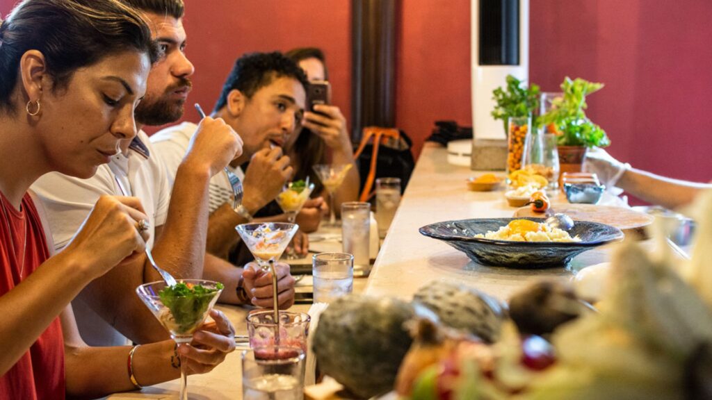 Travelers enjoying a tasting of different preparations of the national dish ¨ceviche¨ | Responsible Travel Peru.