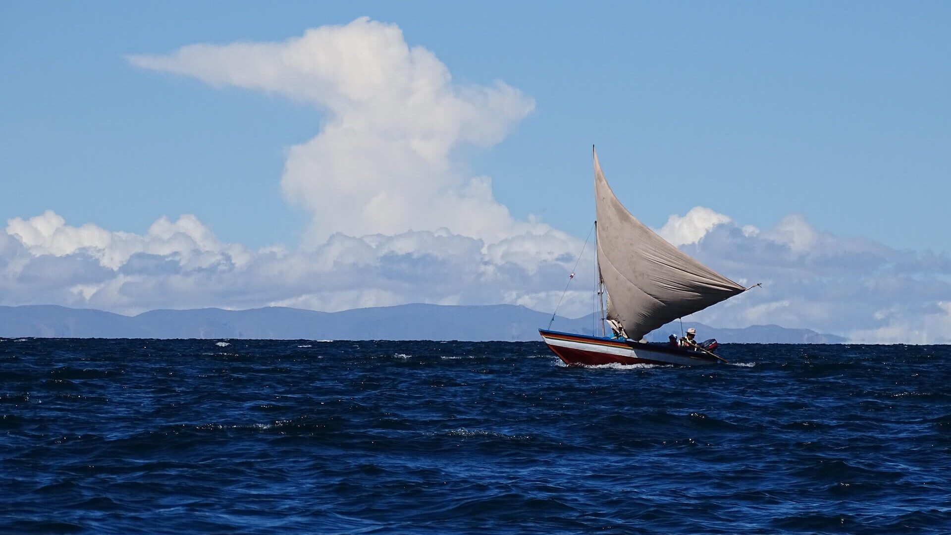 Sailing the waters of Lake Titicaca in a traditional sailboat with RESPONSible Travel Peru