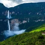 Gocta Panoramic view of Gocta waterfall of 770 meters high in a contrasting dark blue background of the mountains with the bright green of the forest | Impactful Travel Peru