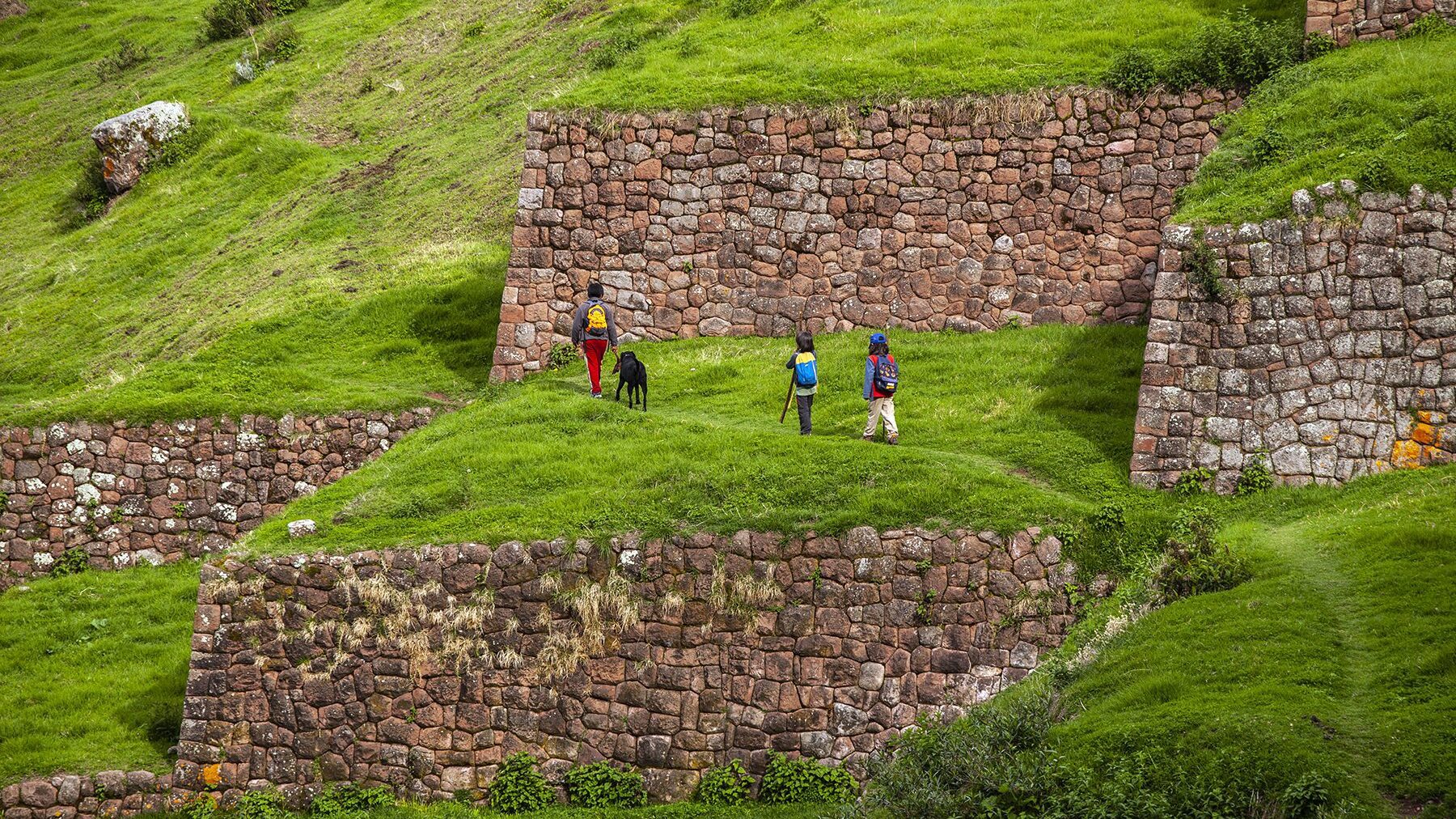 Nice family playing on the Inca terraces of Huchuy Qoso | Responsible Travel Peru