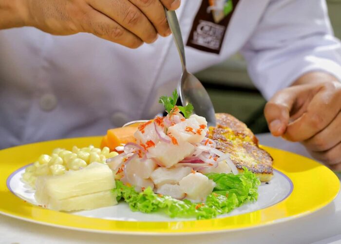 Close up of a chef serving ceviche on a dish | Responsible Travel Peru