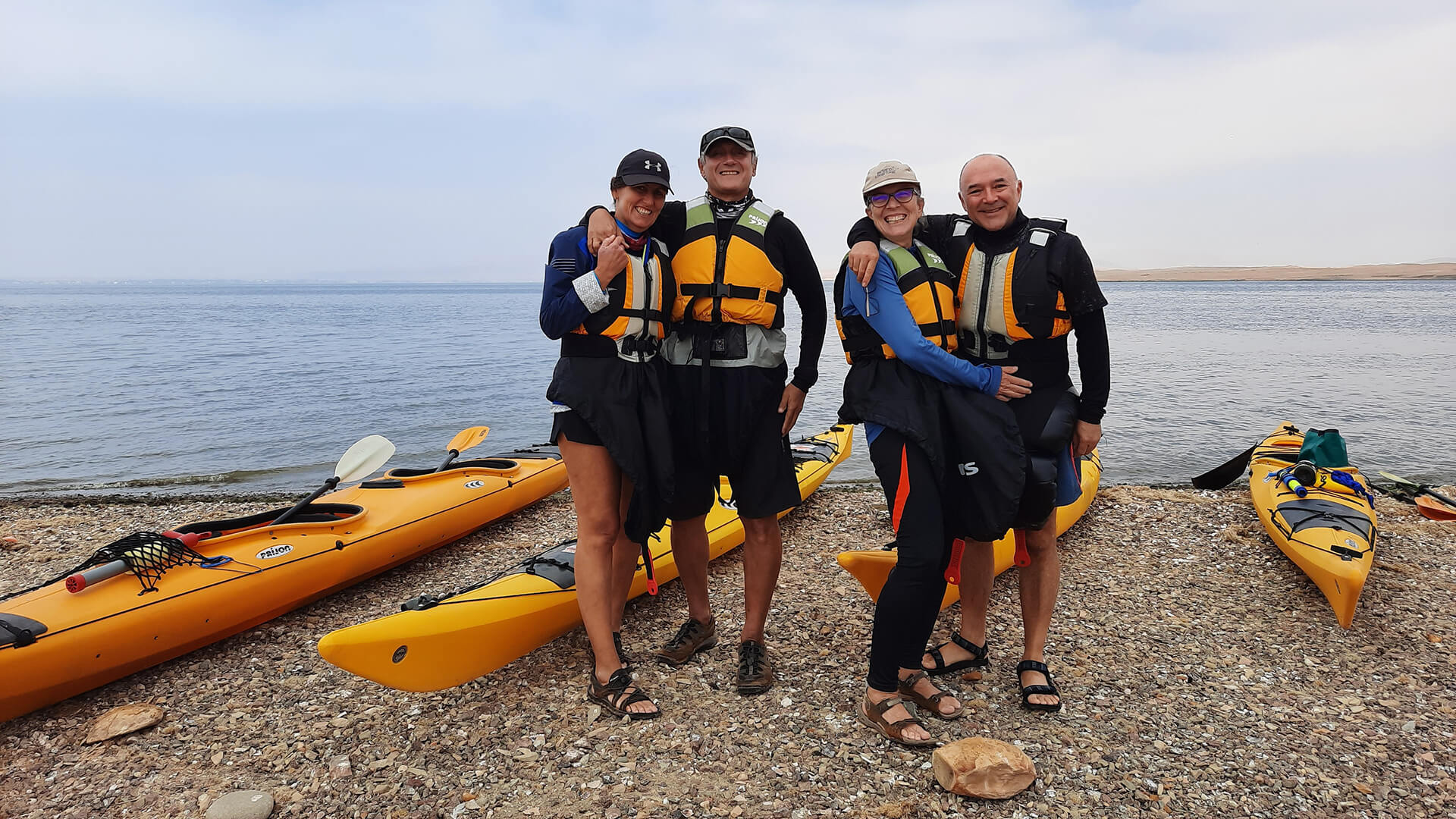 Two couples of senior kayakers smiling at the camera while still on land - RESPONSible Travel Peru