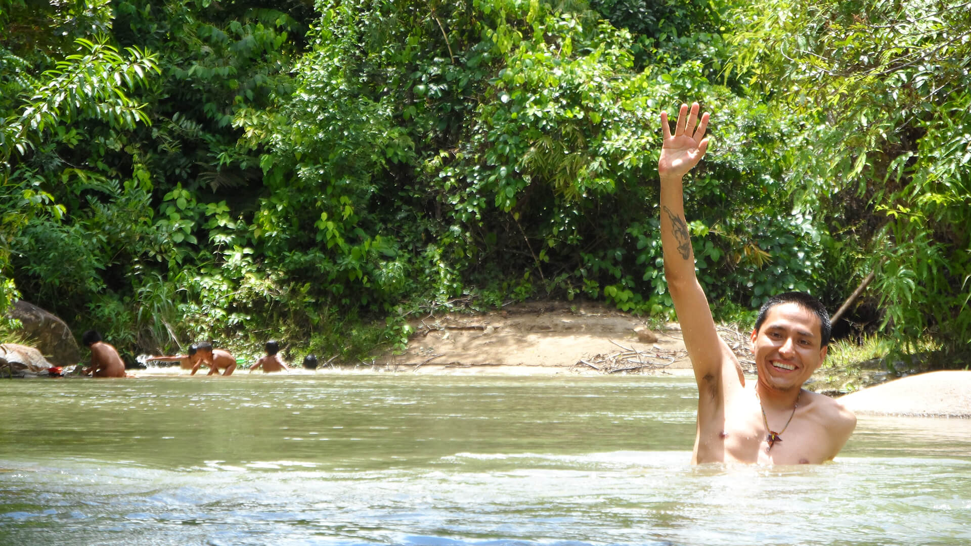 Rosbert bathing in the river where native children of Manu play - RESPONSible Travel Peru