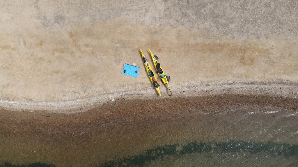 two kayaks and equipment stationed on beach in Paracas