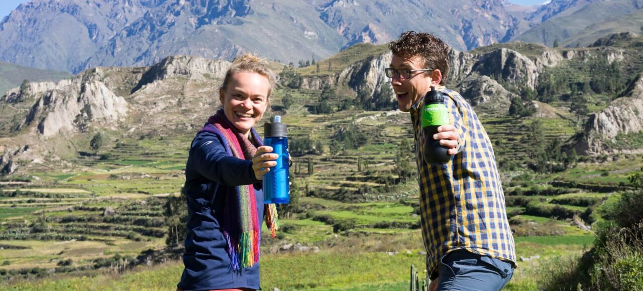 Agnes and Guido from RESPONSible Travel Peru are proudly showing their water bottles with built-in filter on a Road trip through Peru