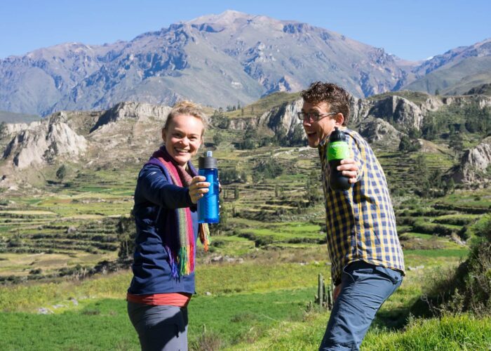Agnes and Guido from RESPONSible Travel Peru are proudly showing their water bottles with built-in filter on a Road trip through Peru