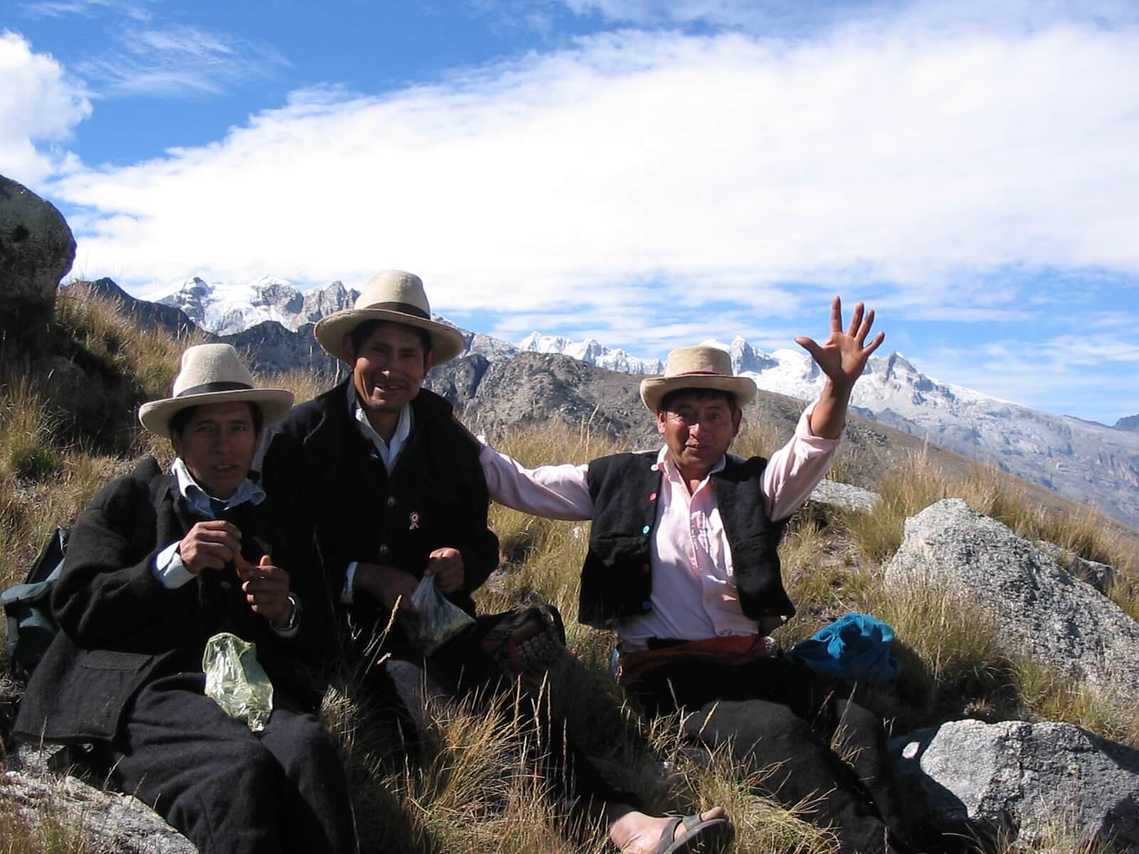 Three men from Vicos wearing traditional clothes and chewing coca leaves in the mountains of Huaraz | RESPONSible Travel Peru