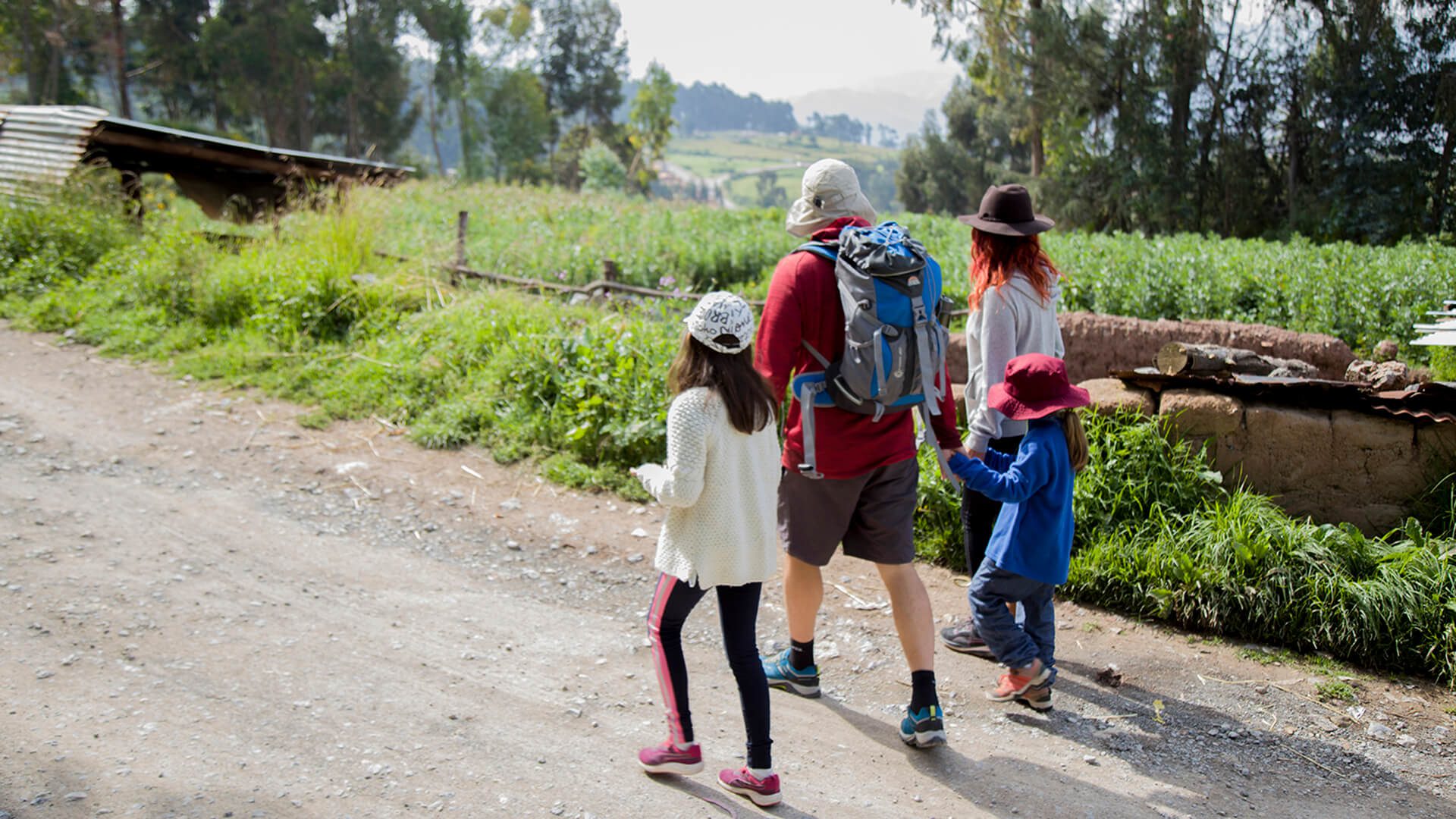 A family with to young girls walking in the countryside out of Cusco city | RESPONSible Travel Peru