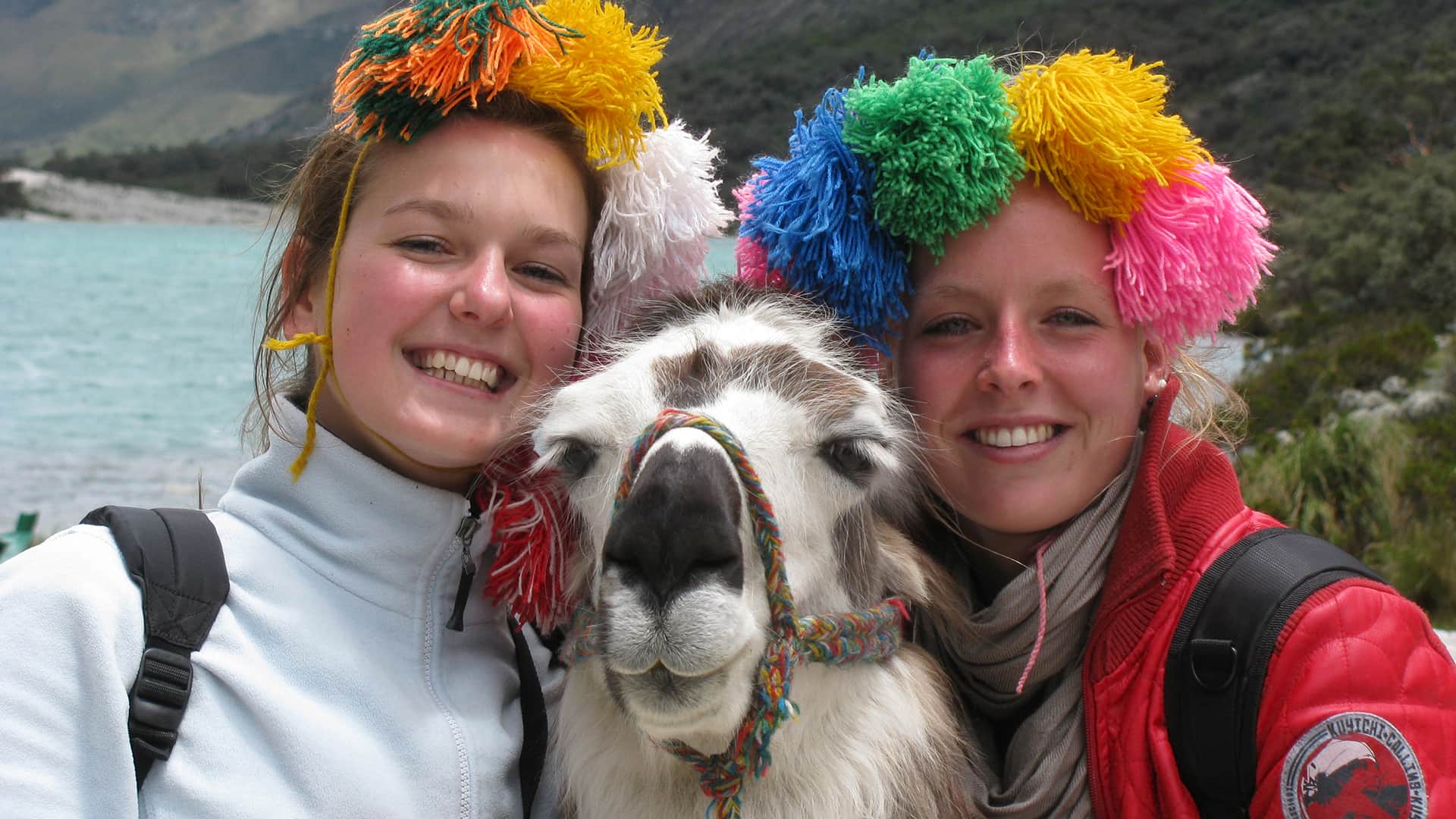 Young students portraying themselves with an adorned llama | RESPONSible Travel Peru