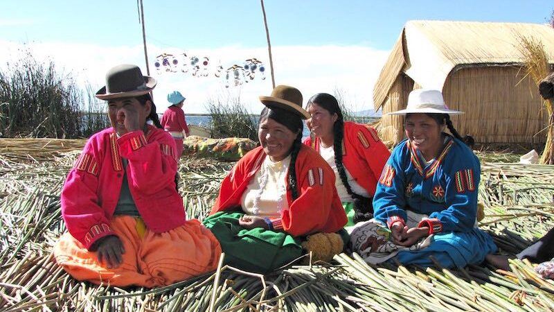 Four smiling women of Uros island in Titicaca