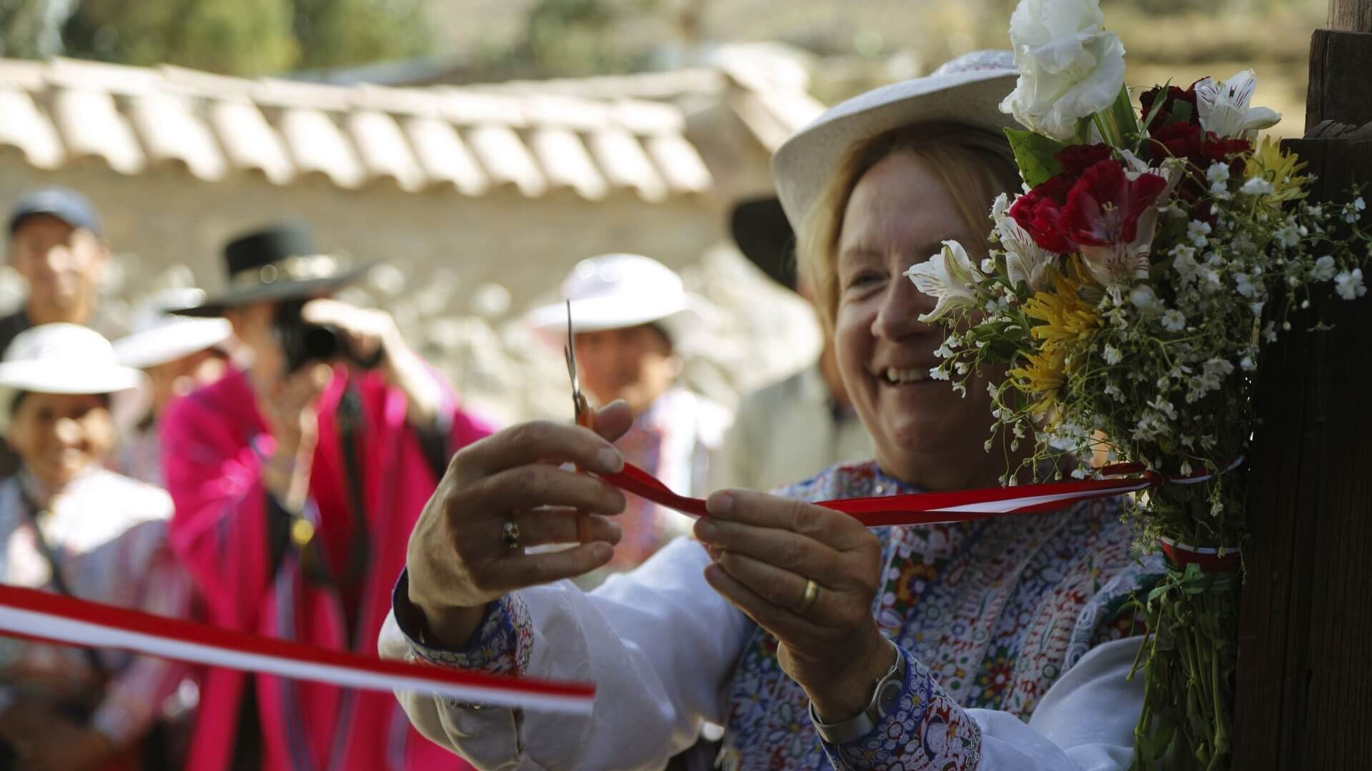 Marianne cutting the ribbon, officially opening the rebuilt homestays in Coporaque. Community-Based Tourism in Peru with RESPONSible Travel Peru.