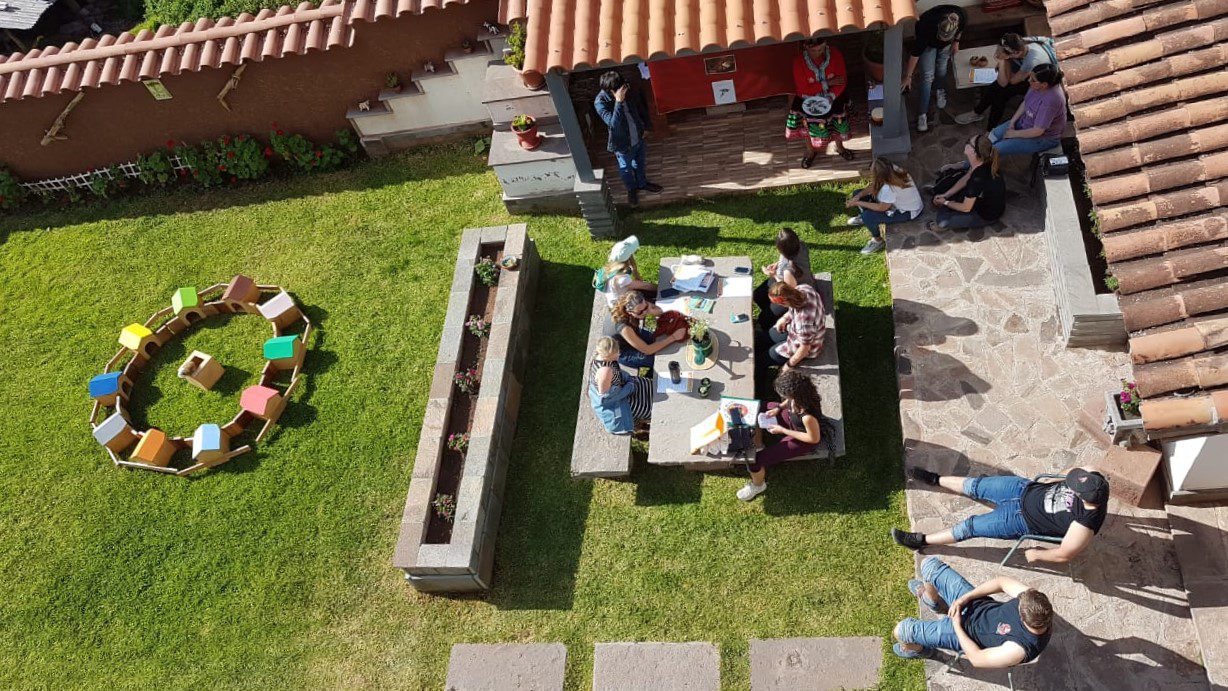 A big group chillin under the sun at Hanaq Wasi's garden - RESPONSible Travel Peru