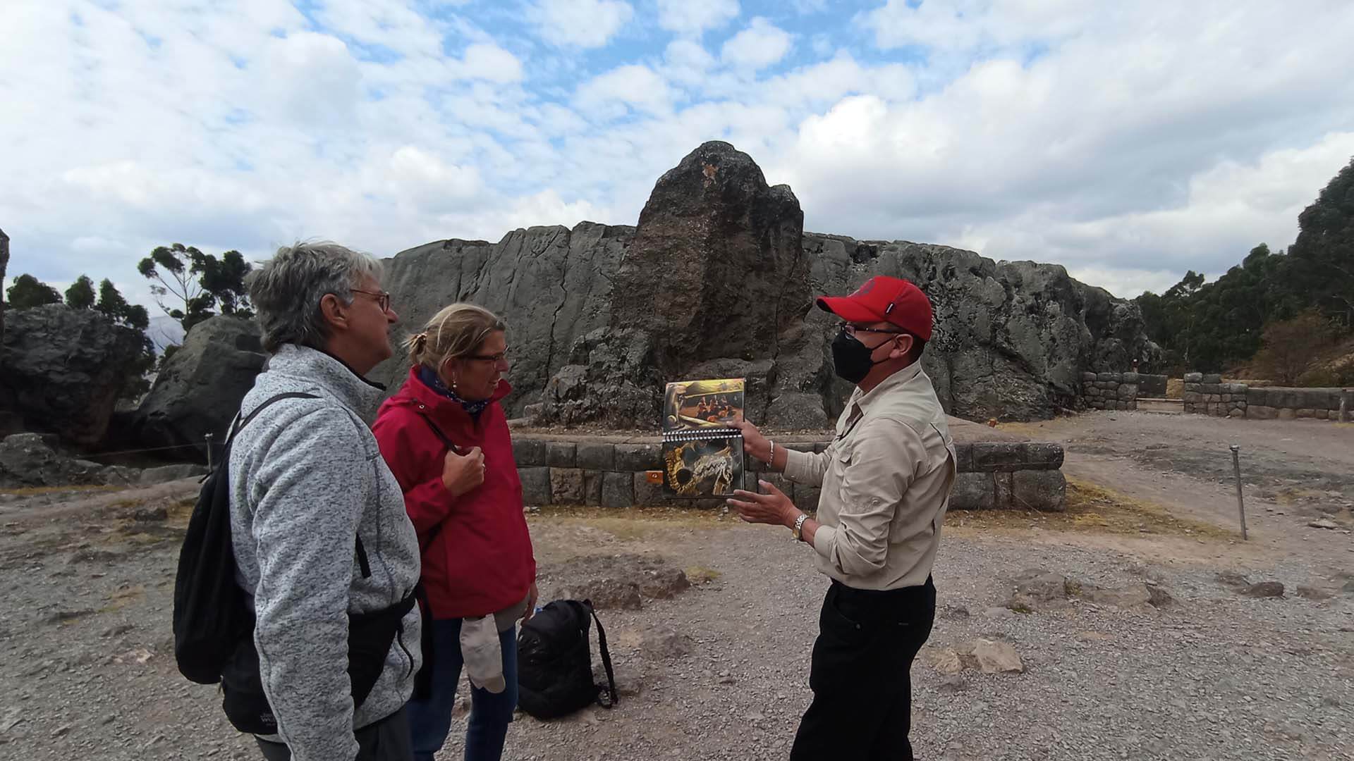 Tourists and tour guide in an archeological site - RESPONSible Travel Peru