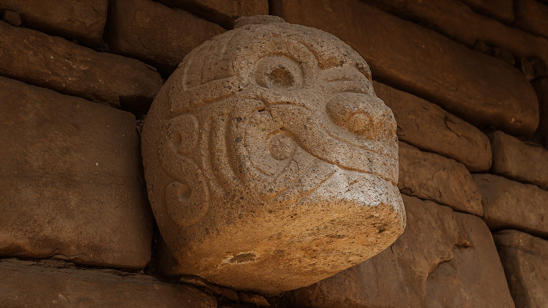 Stone head tucked-in the temple wall of Chavín de Huantar | RESPONSible Travel Peru | Photo by Bjorn Snelders