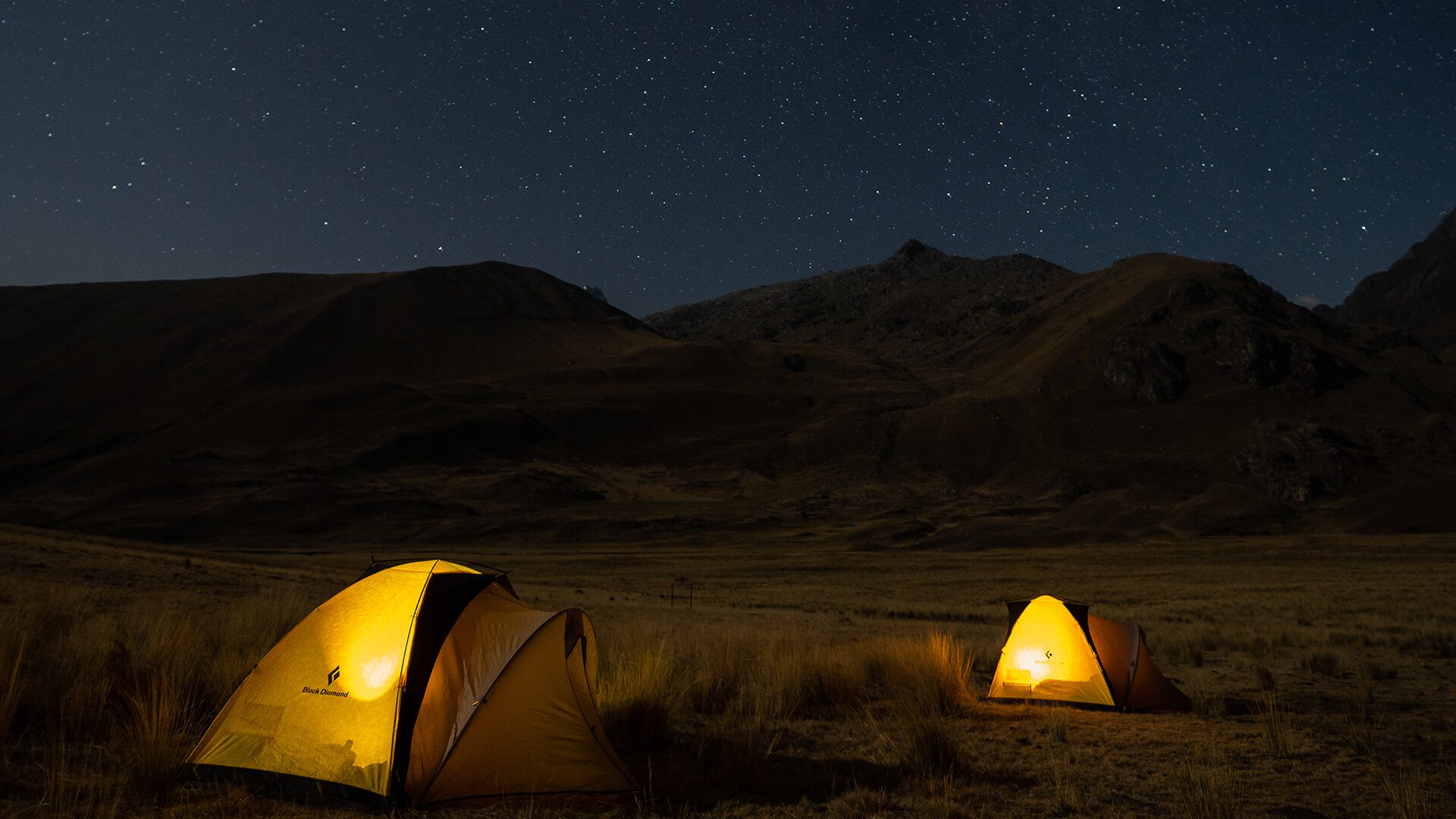 Lit-up tents at night on a starry night in the Andes | Llama Trek Olleros to Chavin with RESPONSible Travel Peru | Photo by Bjorn Snelders