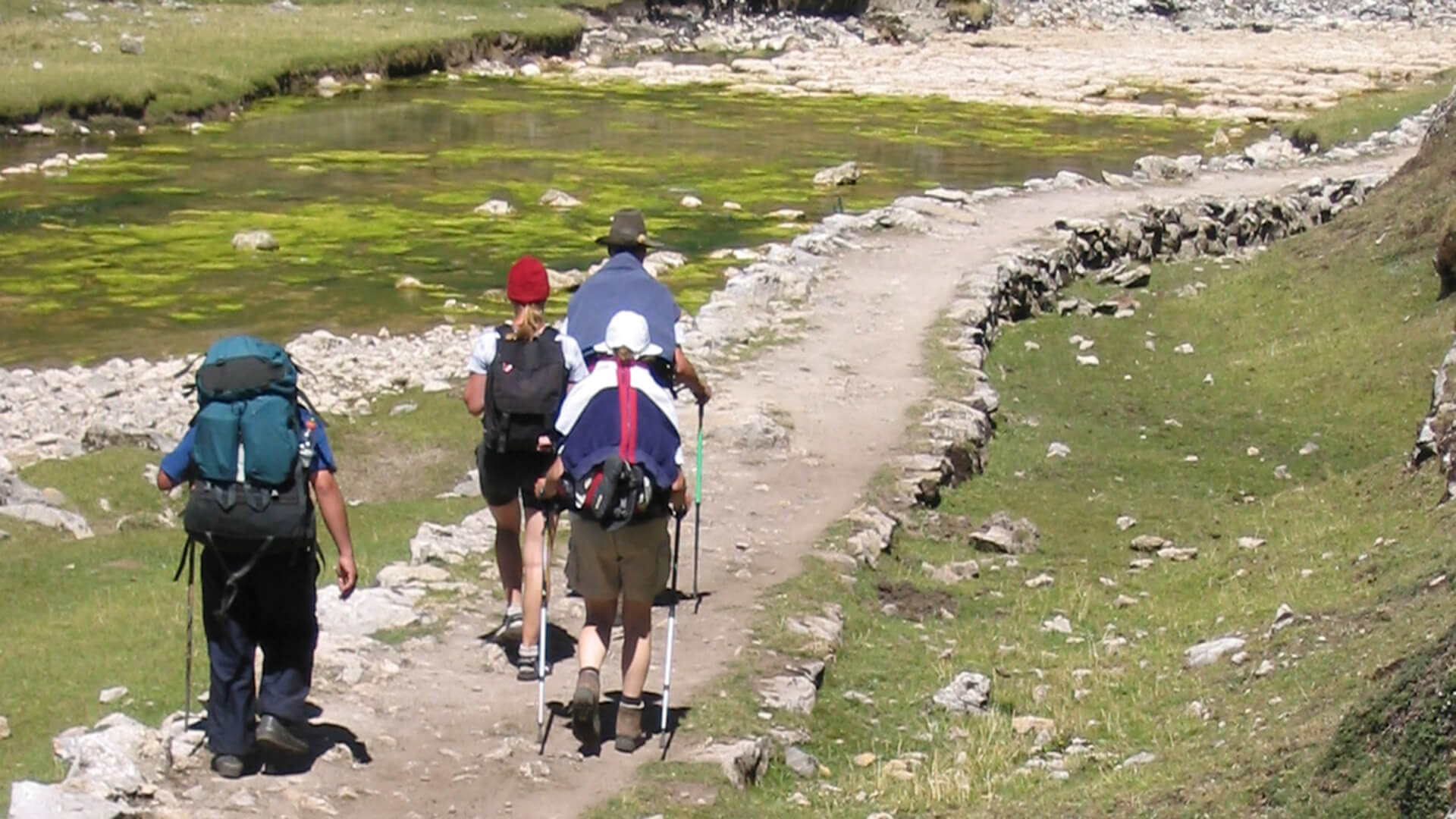 Hikers hiking a spectacular Inca path next to a green river. The Great Inca Road Qhapaq Ñan, Peru | RESPONSible Travel Peru