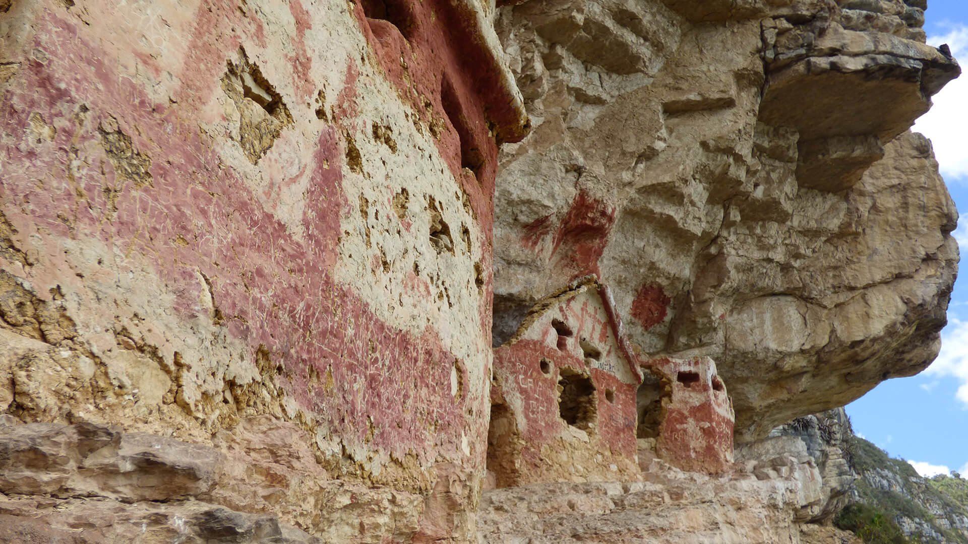 A close-up of the Revash mausoleums located at the mountain's vertical walls