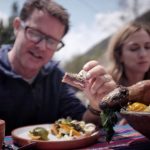 Julie Nolke and Stefan Gates enjoying Andean gastronomy like guinea pig and stuffed rocoto whilst on a shooting trip organized by Impactful Travel Peru