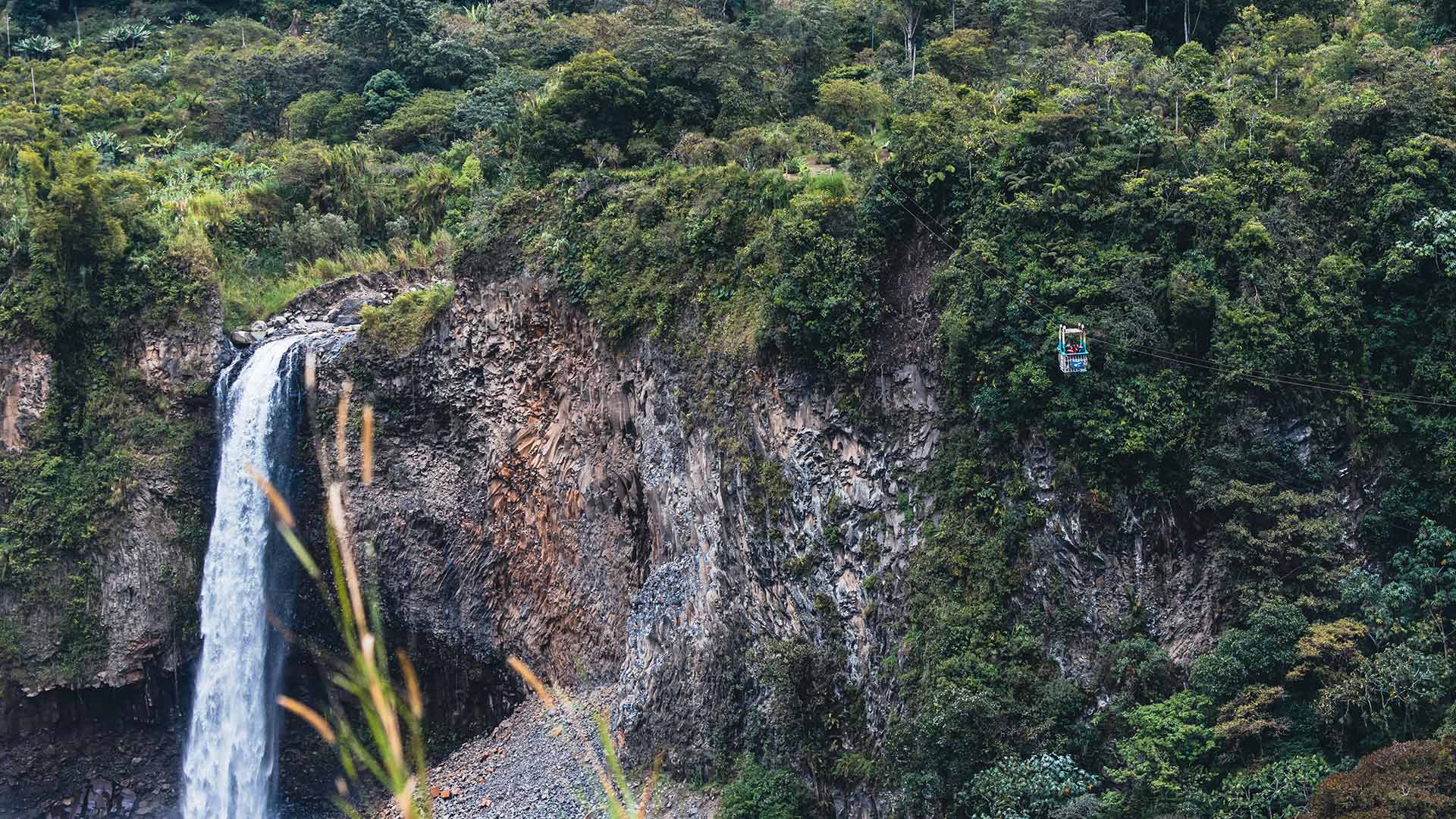 This waterfall near Baños, Ecuador offers you the opportunity to watch it from a cablecar (at your own risk...) | Impactful Travel