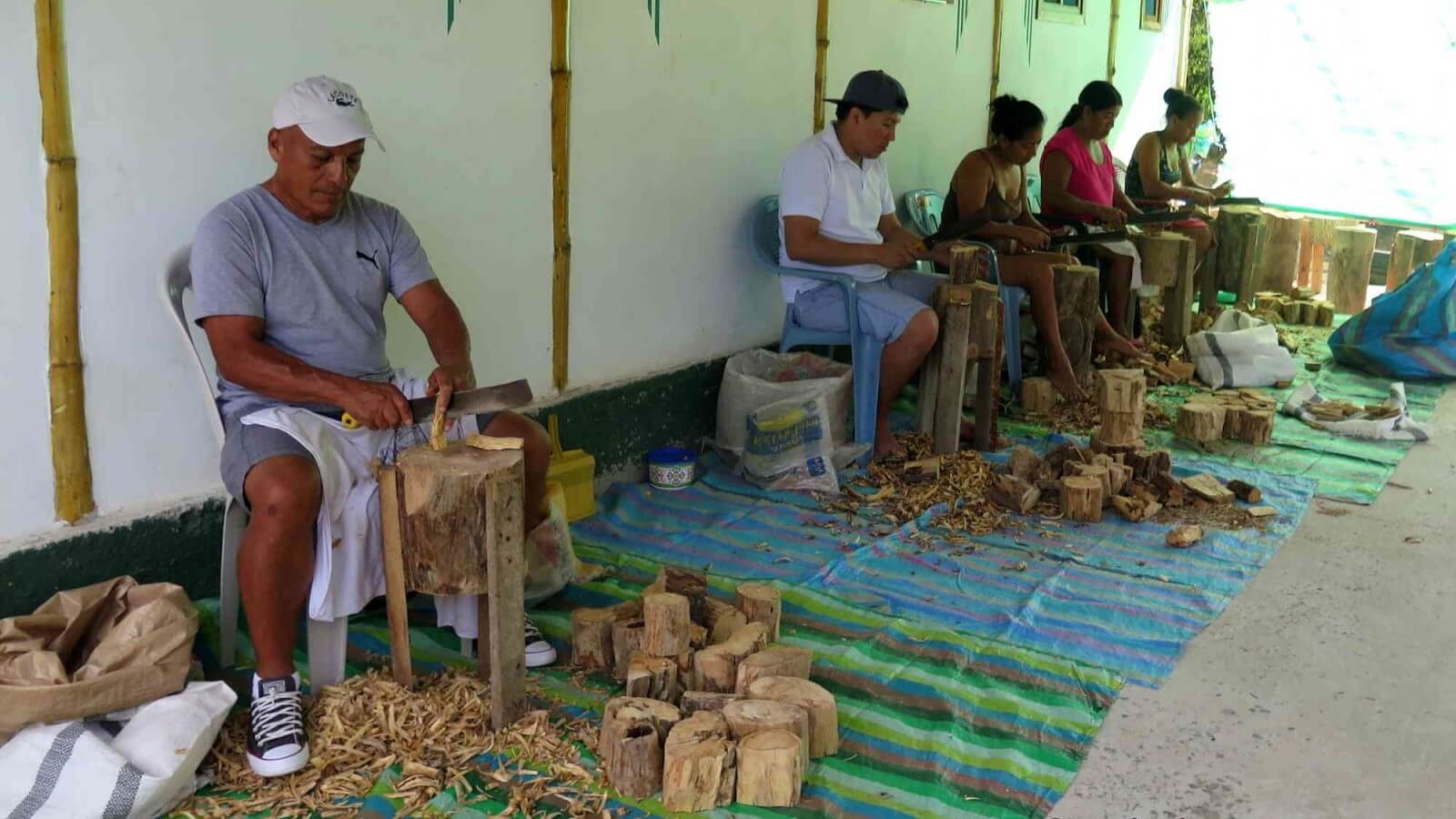 Local people preparing Palo Santo sticks for sales and export. See those specialists at work during your Palo Santo Factory Tour with Impactful Travel in Ecuador.