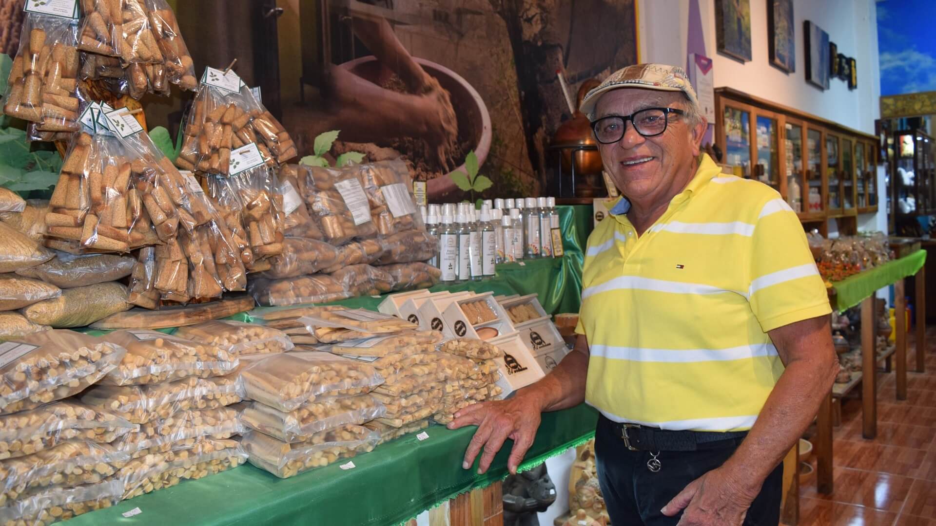 Dante Bolcato, owner of the Palo Santo Factory in Puerto Lopez, Ecuador, next to some final products of his factory | Impactful Travel