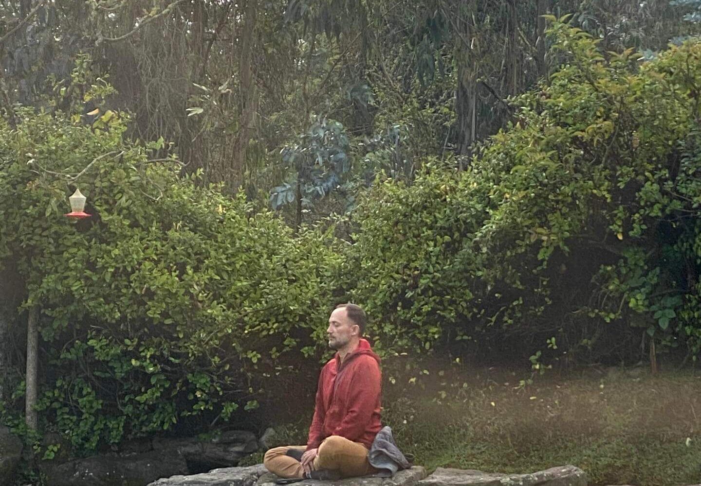 Alex meditating on a rock in the San Clemente commmunity