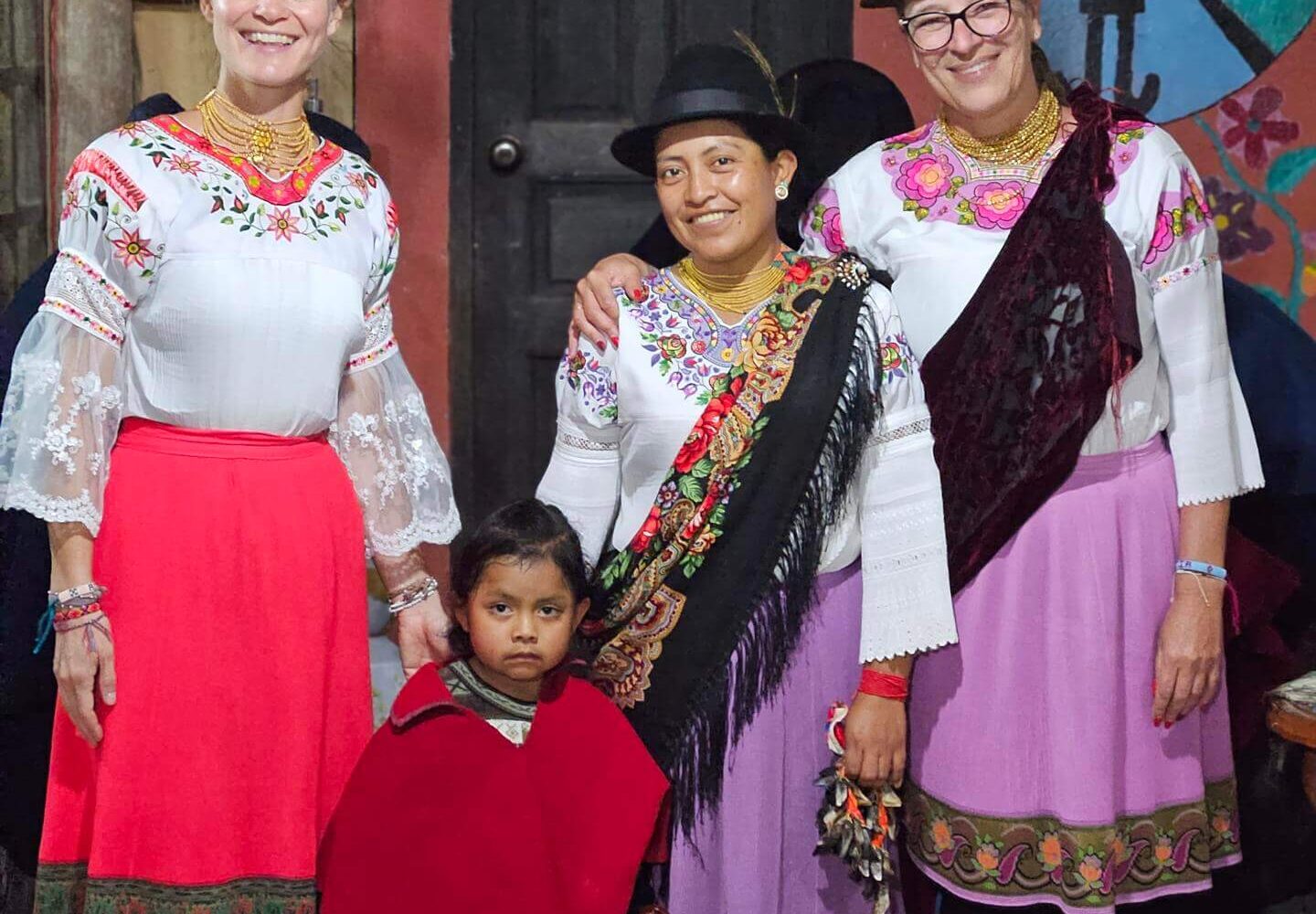 Travelers posing in traditional clothes in the San Clemente community after a cultural night with music and dance. | Impactful Travel in Ecuador