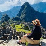 Solo-female-traveler-posing-in-front-of-Machu-Picchu